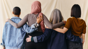 Group of people linking arms, signifying inclusion