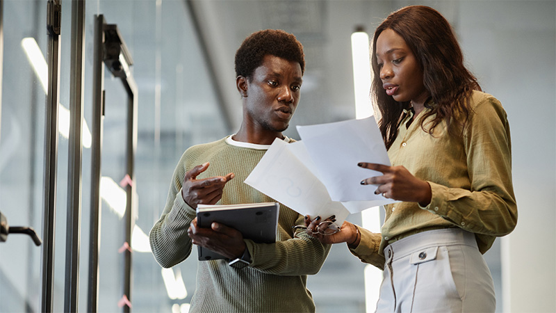 Two professionals looking at a report