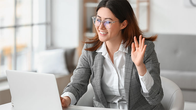 Person waving on a video call