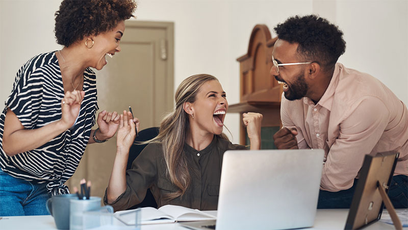 Three colleagues laughing with each other