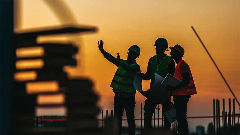 Manager speaking to colleagues on construction site