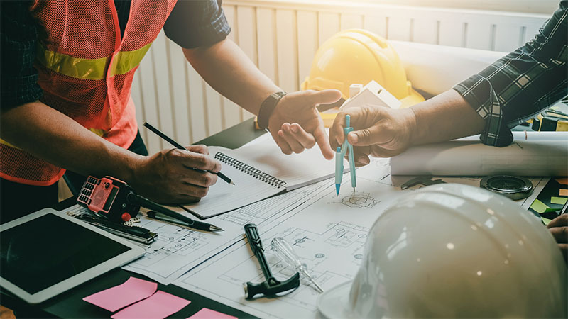 Construction workers looking at plans together