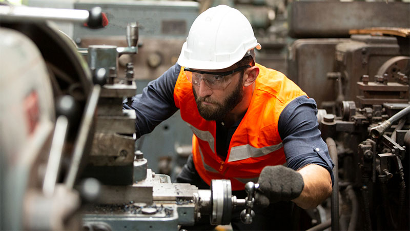 Person working on machinery in production setting